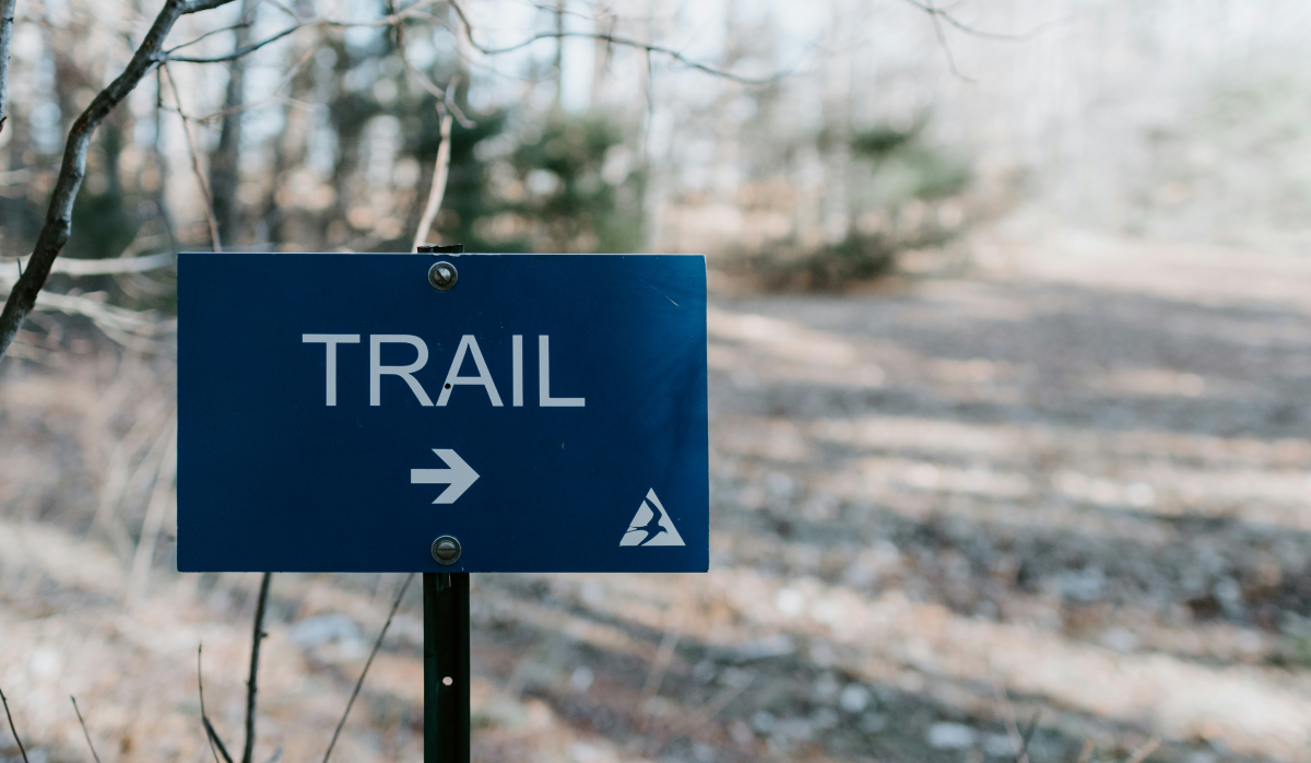 image of sign with words Trail and an arrow pointing right