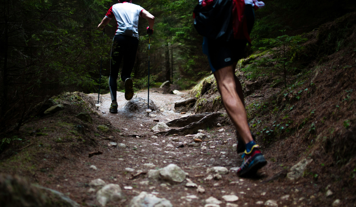 2 people running on a trail