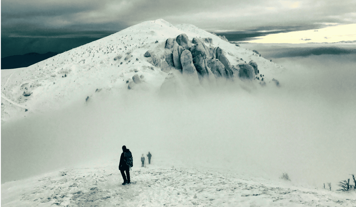 Mount Gorichen and people walking through snow